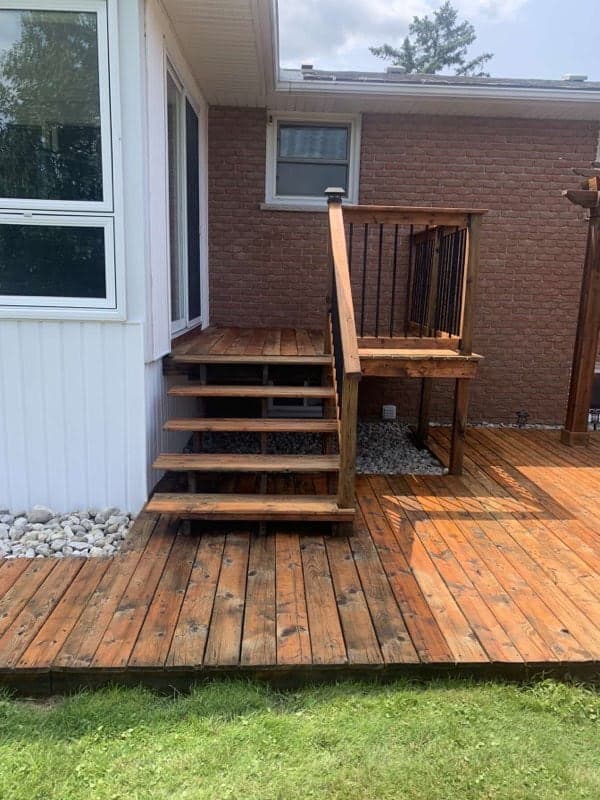 Freshly stained deck - warm brown finish on pressure-treated wood